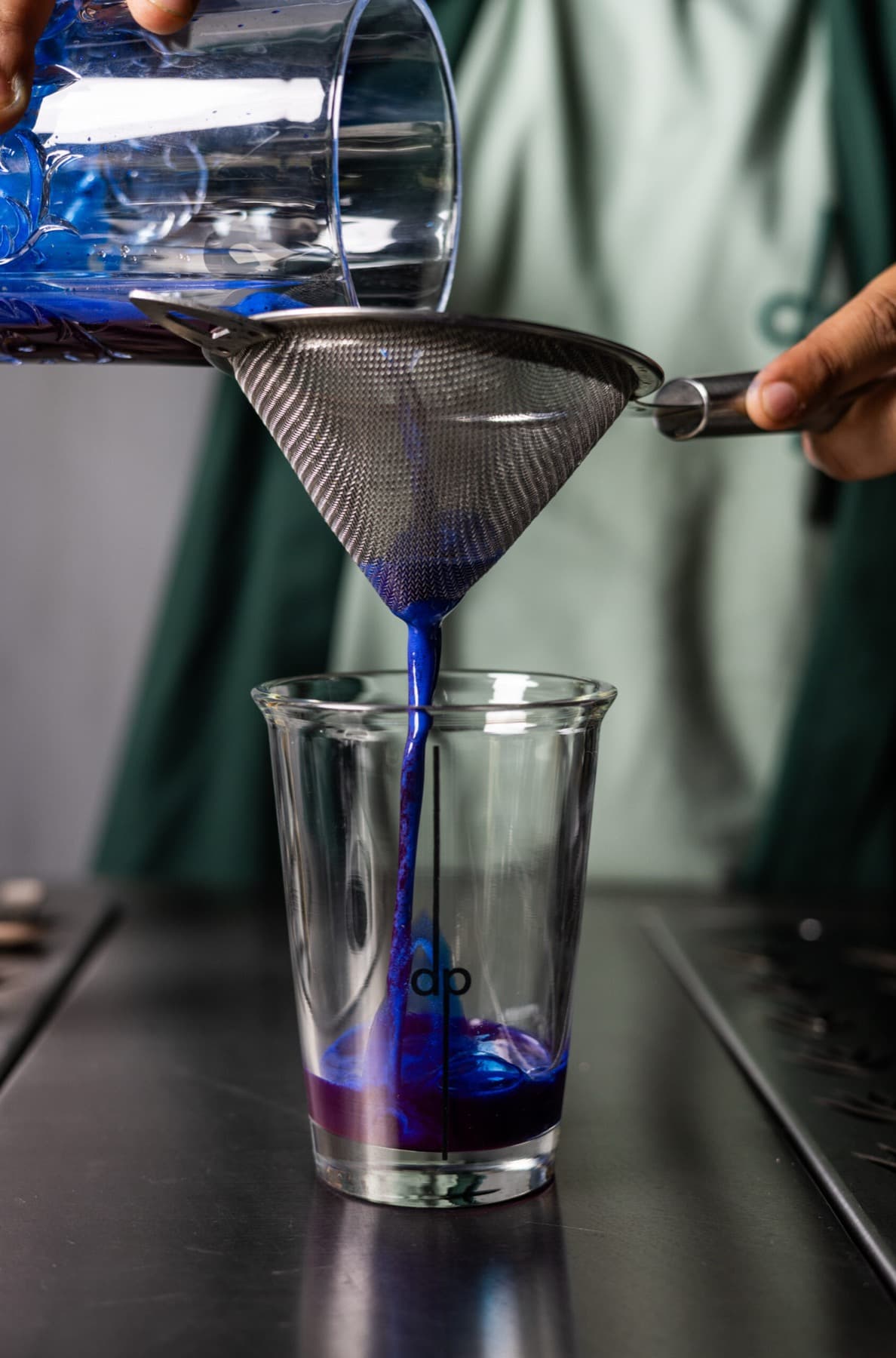 Butterfly-pea pour strained into a layered drink