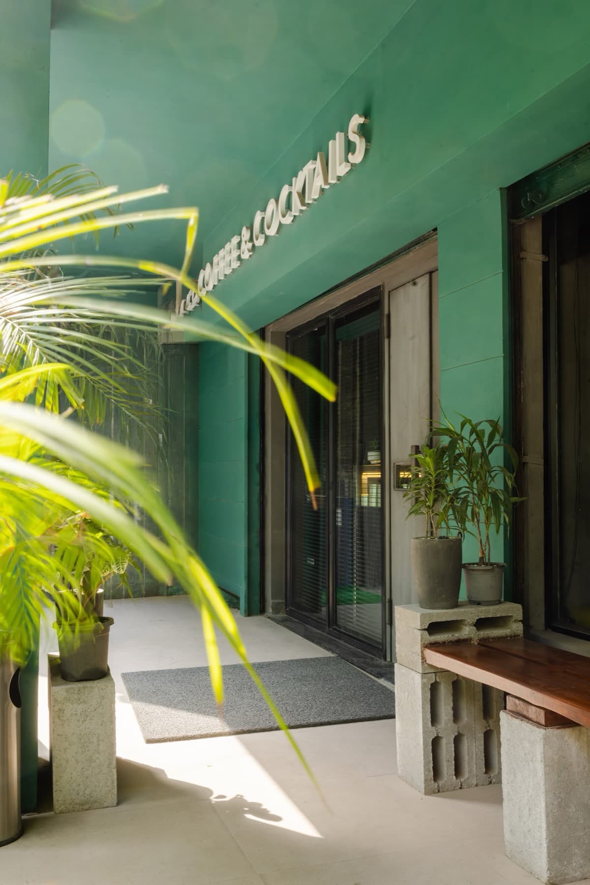 The DROP entrance — pine green façade